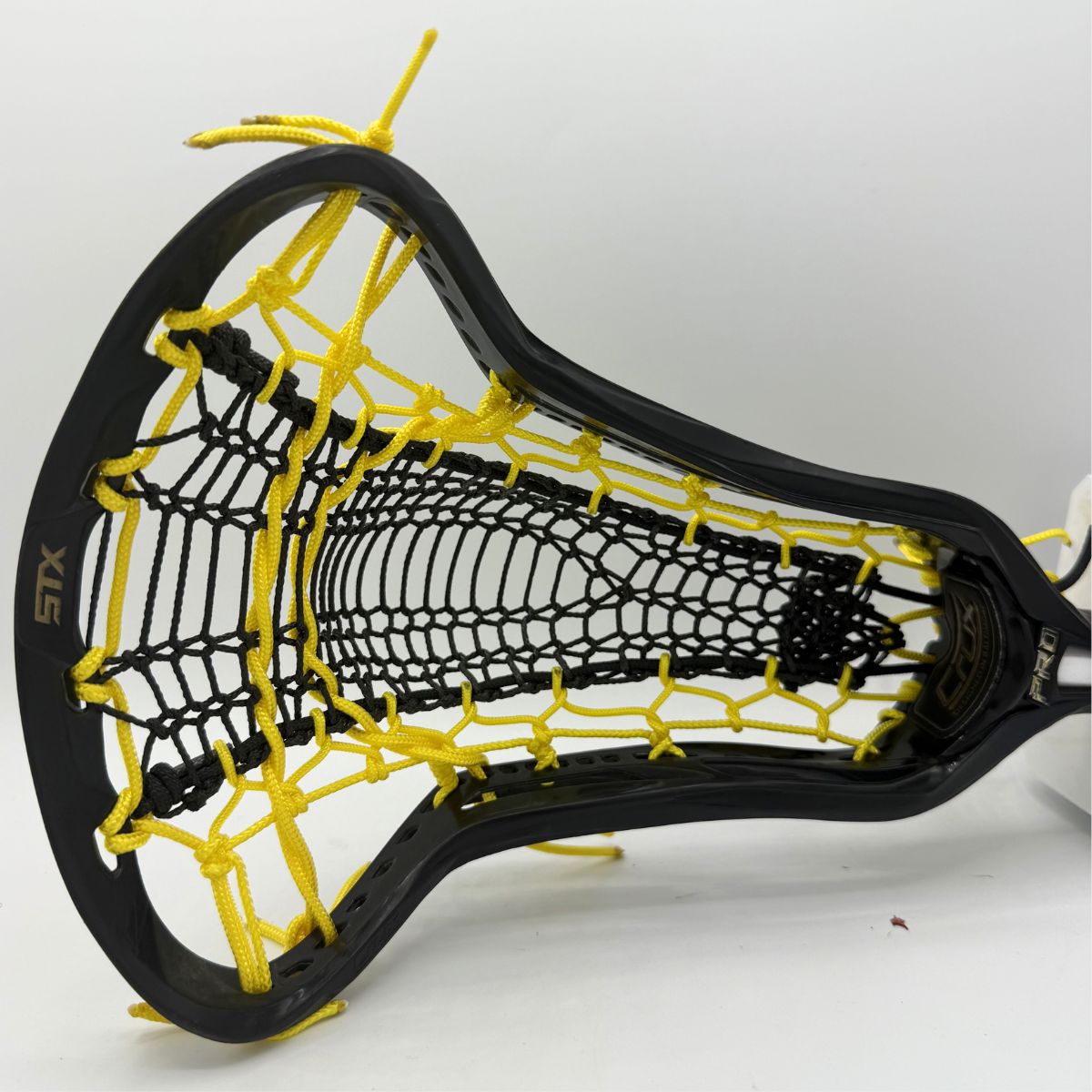 black womens stx lacrosse head with black valkrie runner and yellow strings strung by stringers society