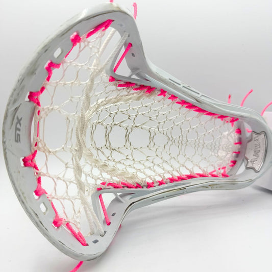 A close-up of a white lacrosse head with white mesh and bright pink thread accents, photographed on a clean white background.