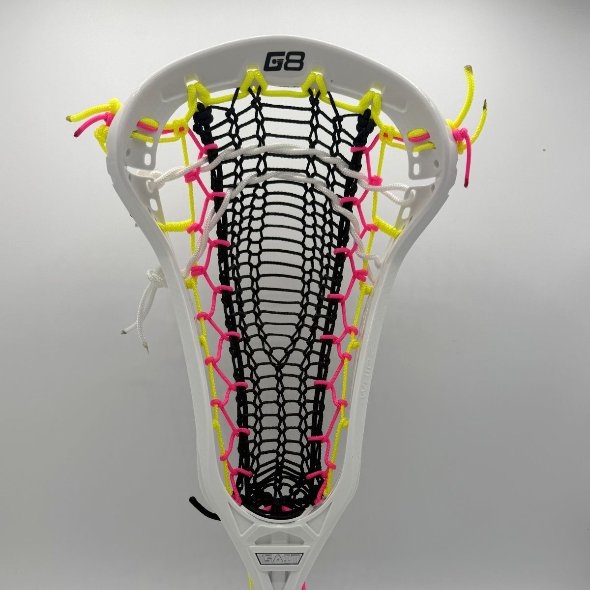 White lacrosse head with colorful strings on a gray background